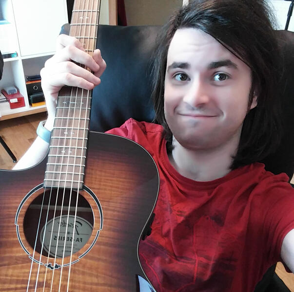 Chris holding a Guitar